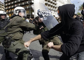 Clashes broke out as tens of thousands of strikers marched through Athens on Wednesday to protest against austerity plans forced on Greece